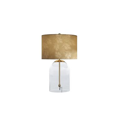 Estila Glamour zlatá stolná lampa Gambier s okrúhlym tienidlom so vzorom palmových listov a priehľadnou sklenenou podstavou 55 cm