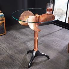Estila Koloniálny okrúhly príručný stolík Helice s nohou v medenej farbe s dizajnom lodnej skrutky a sklenenou vrchnou doskou 73 cm